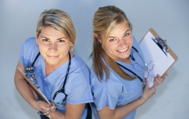 two_nurses_from_above_smiling_clipboards
