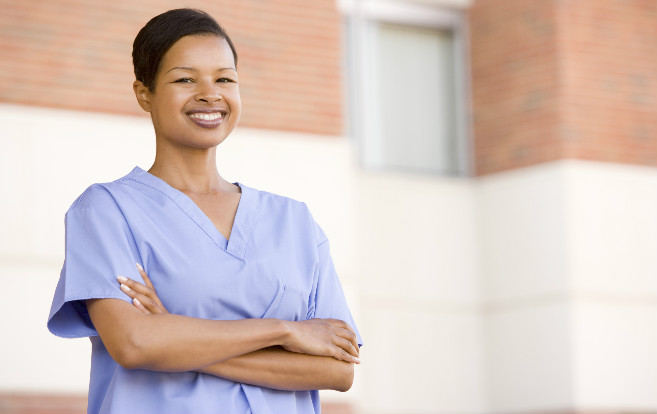 African_American_nurse_standing_outside_hospital