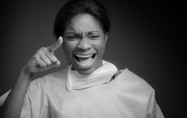 African_American_woman_screaming_or_yelling_pointing_finger_at_camera_black_white_image