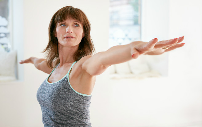 mature_woman_warrior_yoga_pose_exercise_balance_focus