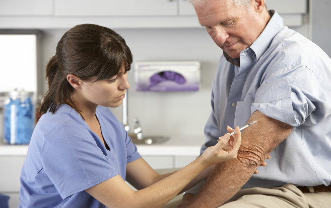 nurse_giving_senior_patient_injection_flu_shot