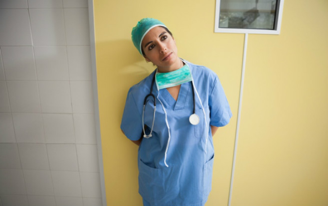 nurse_surgical_attire_looking_off_thinking_hospital_corrider