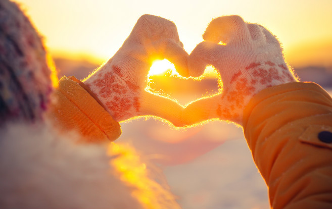 winter_holidays_mittened_hands_making_heart_shape