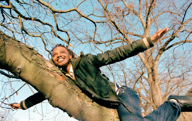 woman_balancing_branch_outdoors_smiling
