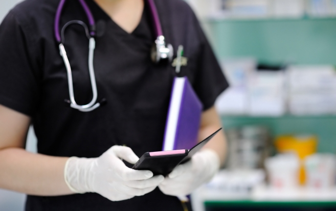Nurse wearing gloves with phone